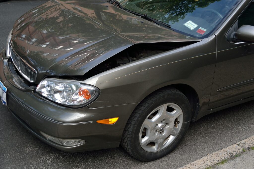 car with dent in its hood