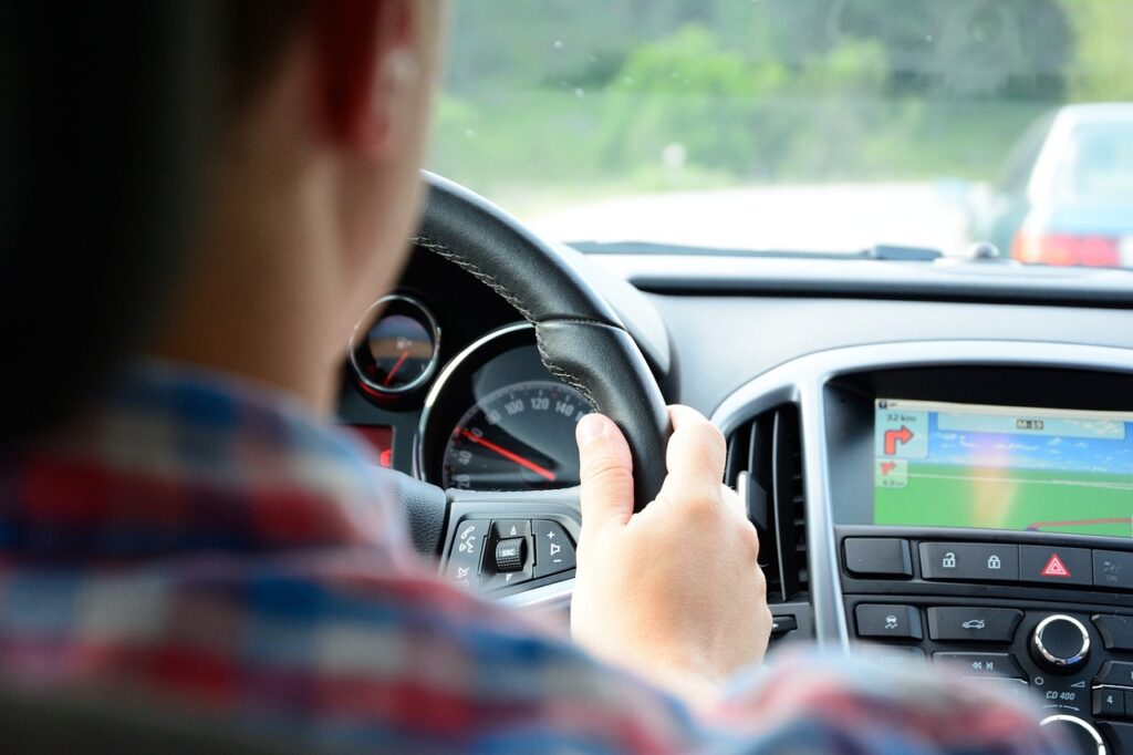 view of steering wheel from behind a girl driver