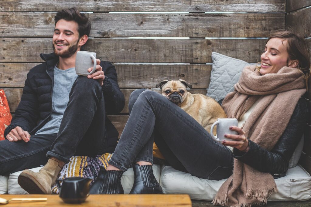 couple sitting down with pug