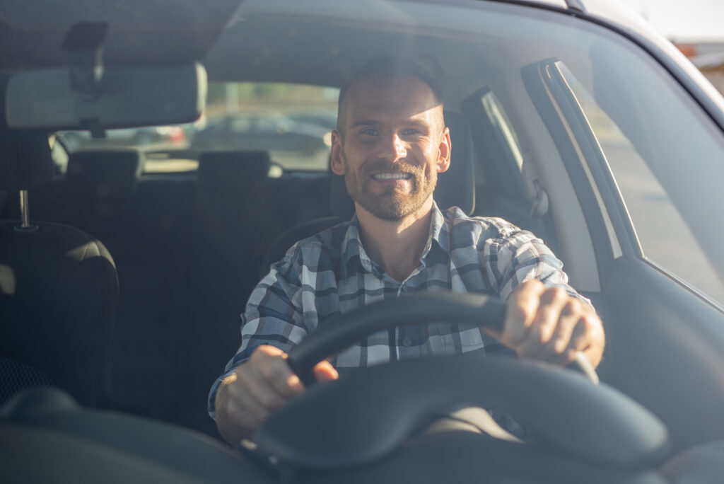 Adult man driving a car