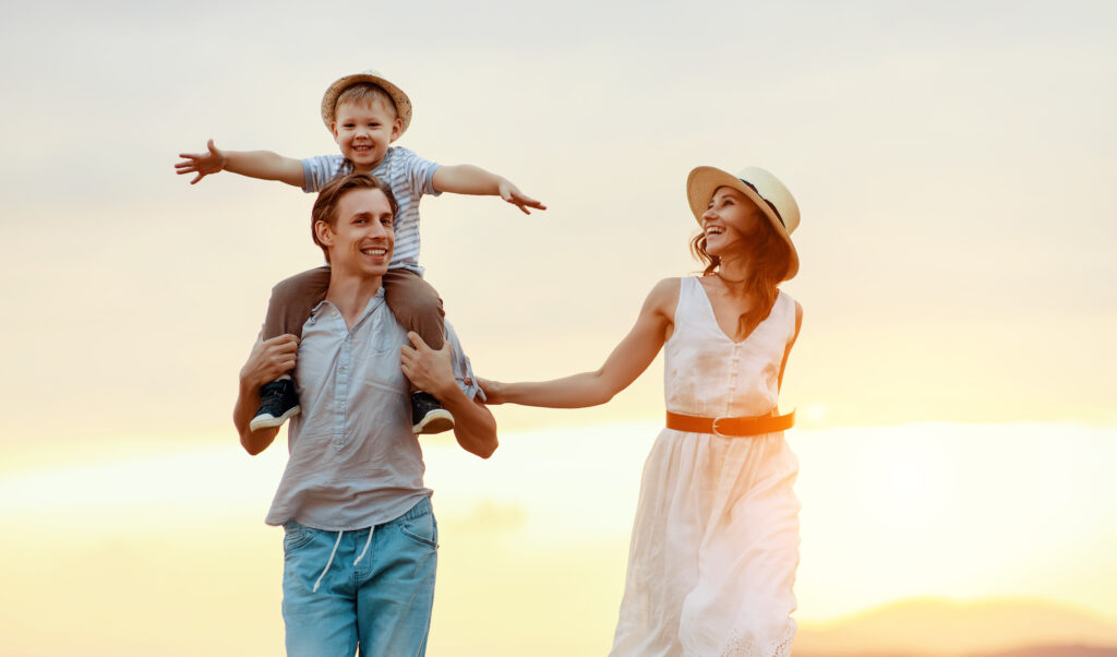 Happy family at sunset