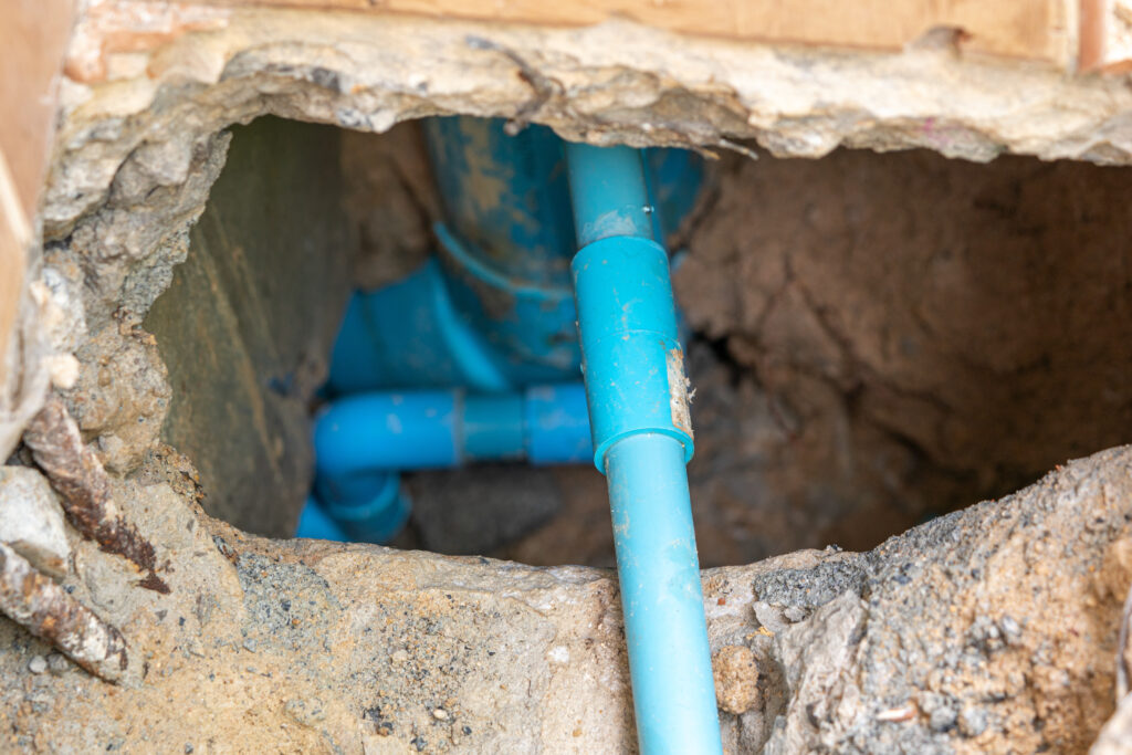 leaking water from blue pipe from underground