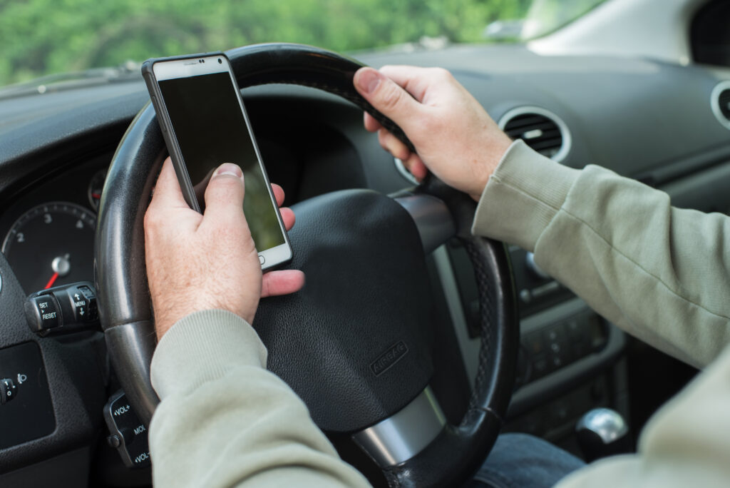 Man texting while driving