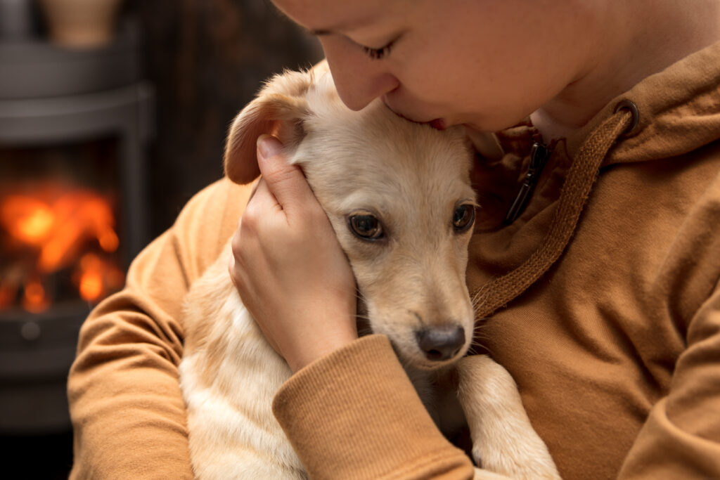 Woman cuddling a dog